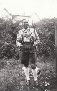 Martin Ansbacher wearing traditional Tracht country clothing - Bavarian Oak Leaf Jacket, Lederhosen, white socks with flashes (frills)